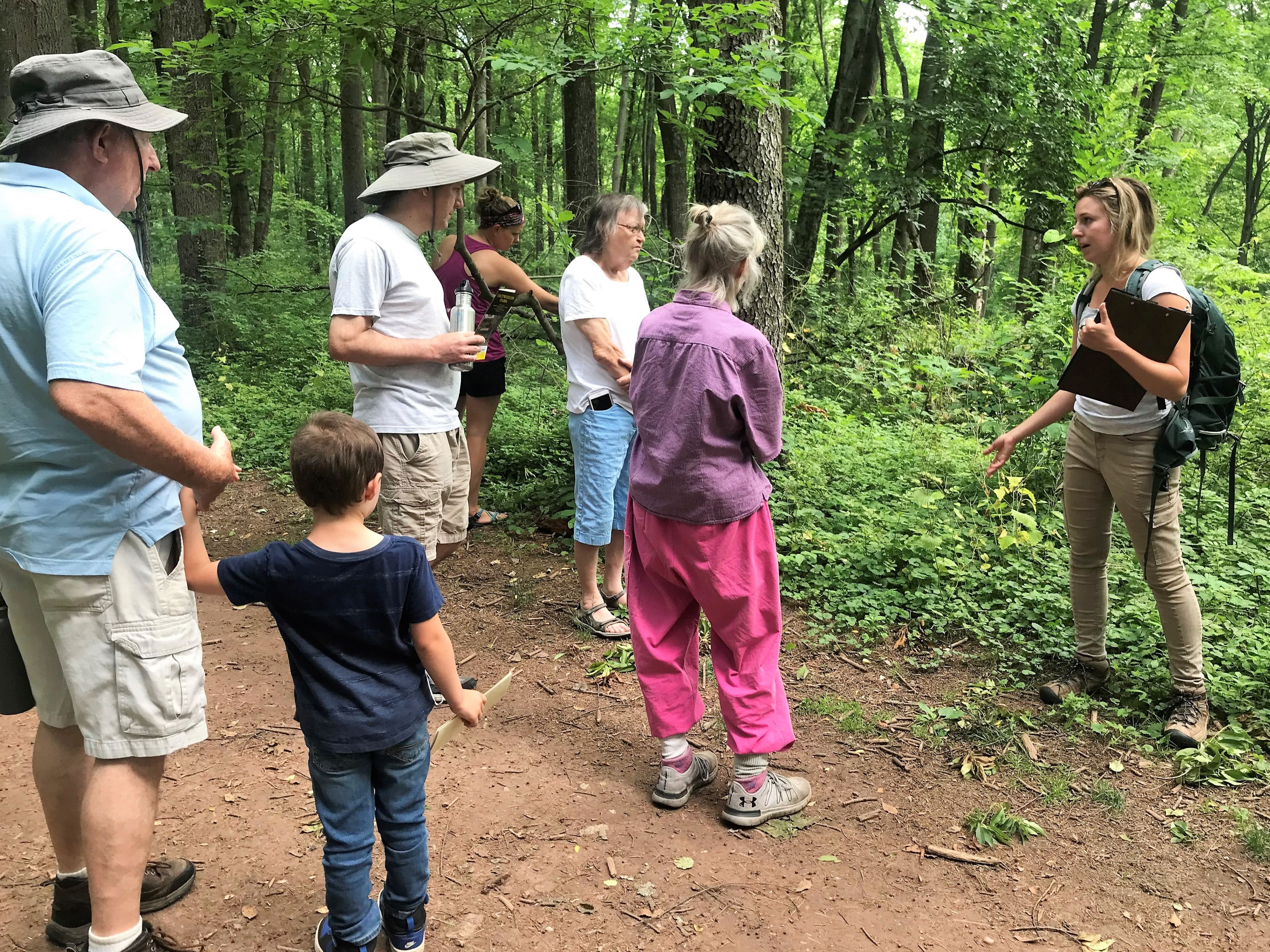 Group of people in the woods learning about nature