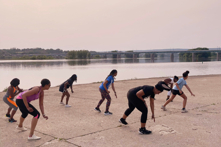 People doing cardio exercise along the riverfront