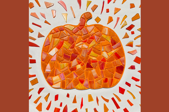 Pumpkin made out of mosaic glass pieces in various shades of orange and yellow