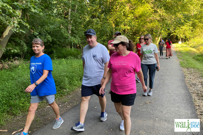 People walking along a paved path at wildwood park